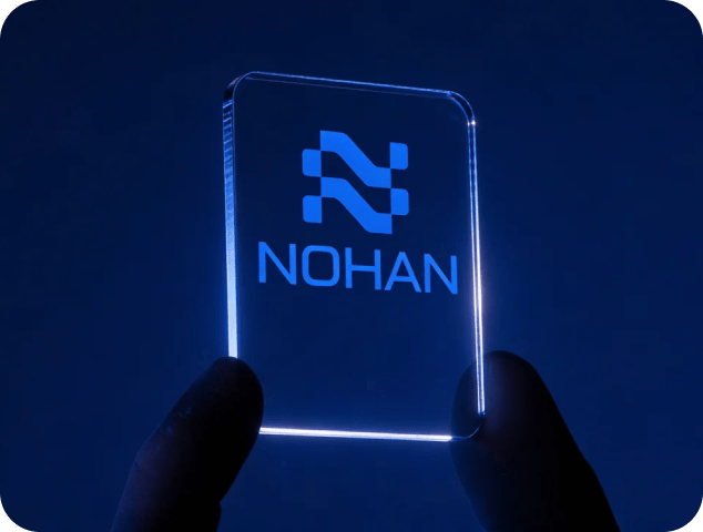 Glowing acrylic card displaying Nohan Agency logo with blue neon effect